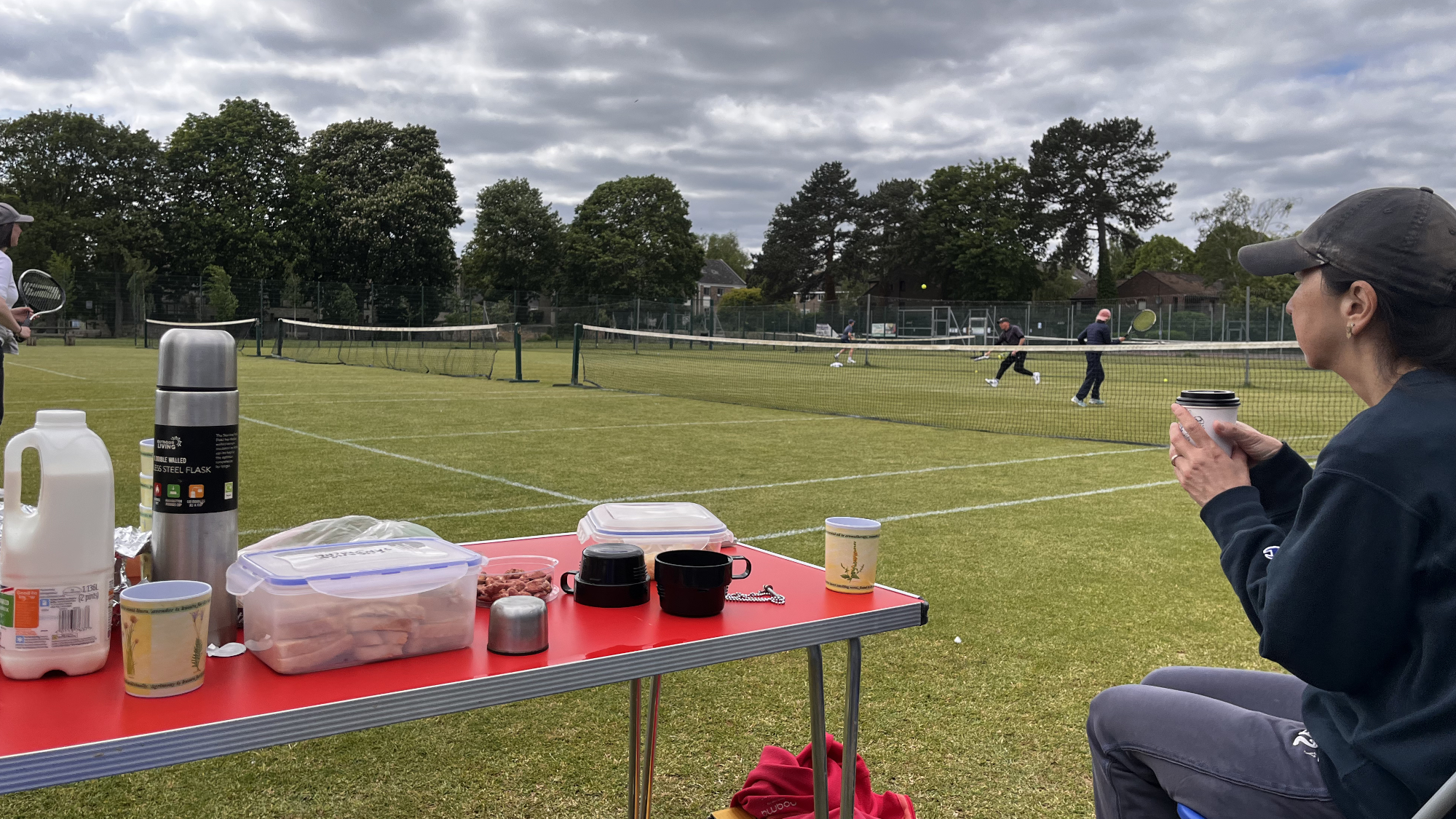 Pondering this year's club tournament. Ellen looks out for competitors at Tea and Tennis